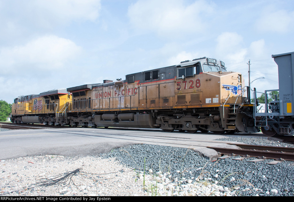 UP 5728 trails on a westbound empty stone train 